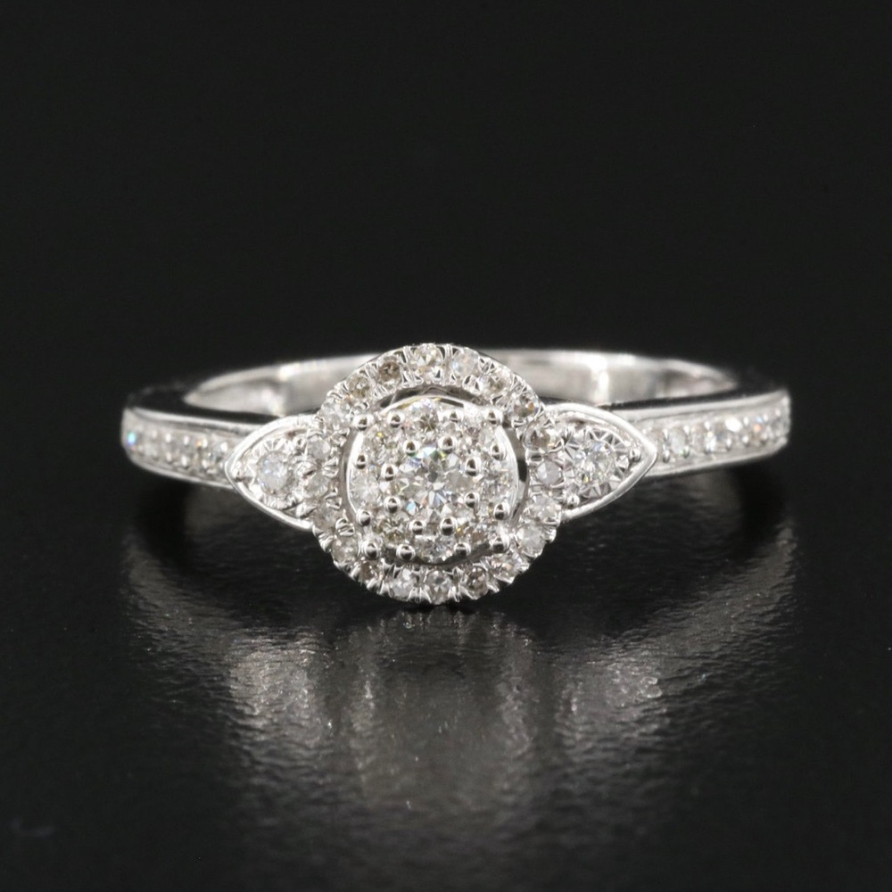 10 karat gold, 0.27 carat total weight diamond cluster halo ring.